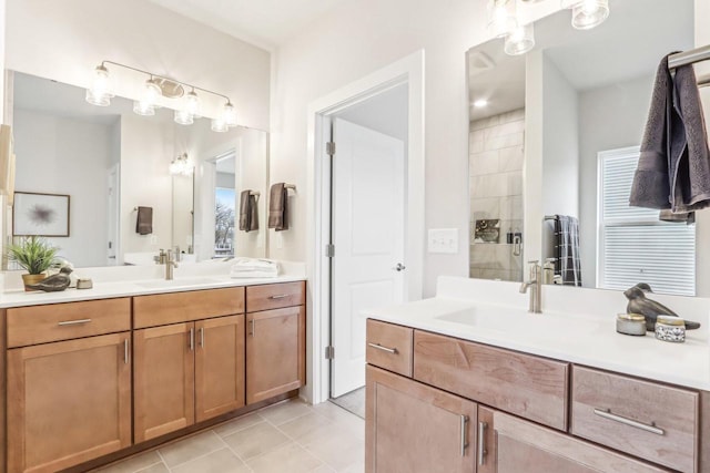 bathroom with tile patterned flooring, two vanities, a sink, and a shower stall