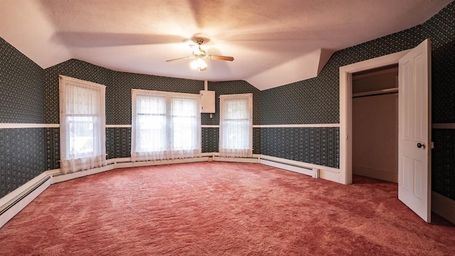 unfurnished bedroom with carpet flooring, ceiling fan, a textured ceiling, and vaulted ceiling