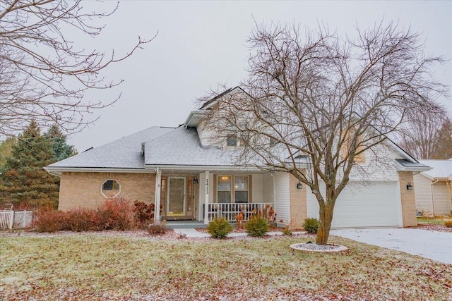 view of front of house featuring a front lawn, a porch, and a garage