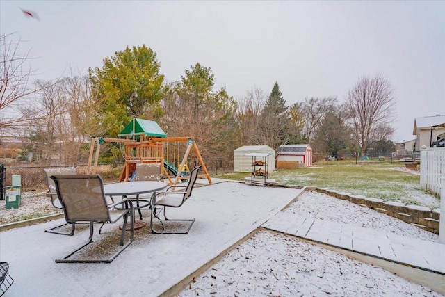 view of patio with a storage unit and a playground