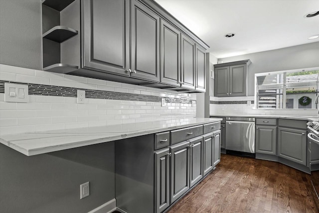 kitchen with stainless steel dishwasher, gray cabinetry, light stone countertops, and dark wood-type flooring