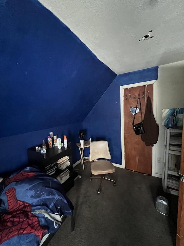 bedroom with carpet floors, a textured ceiling, and vaulted ceiling