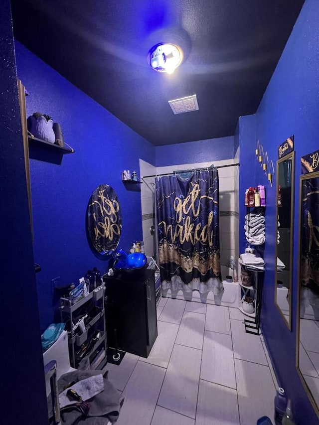 bedroom featuring light tile patterned flooring