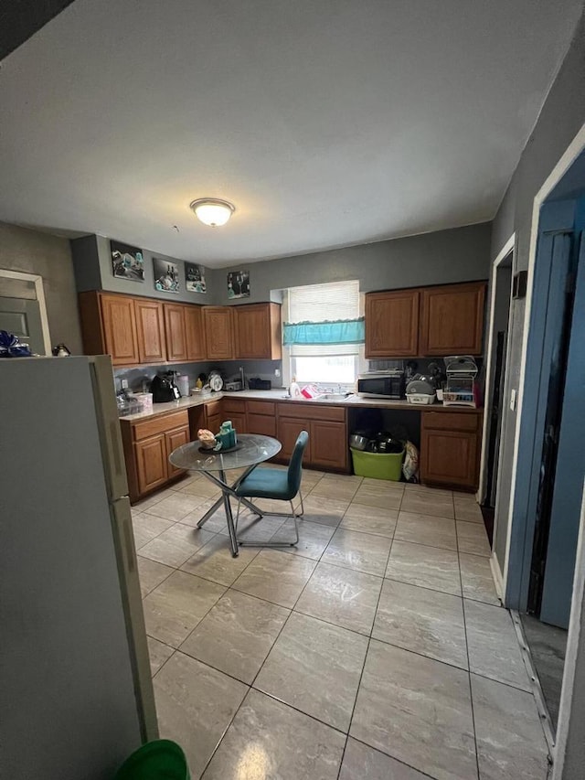 kitchen featuring decorative backsplash, white fridge, and light tile patterned flooring