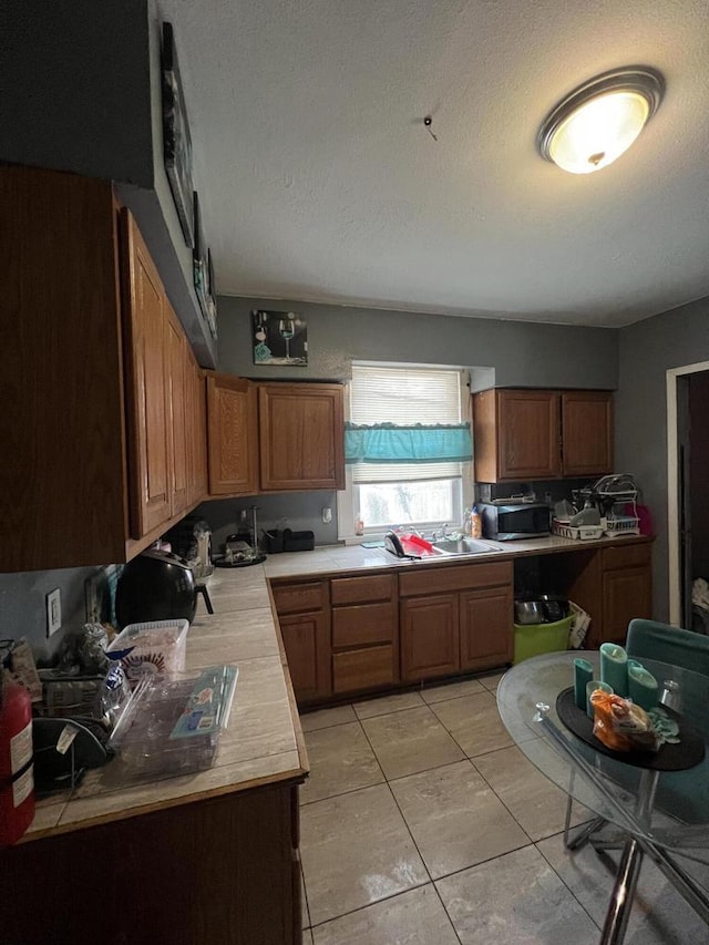 kitchen with light tile patterned floors and a textured ceiling