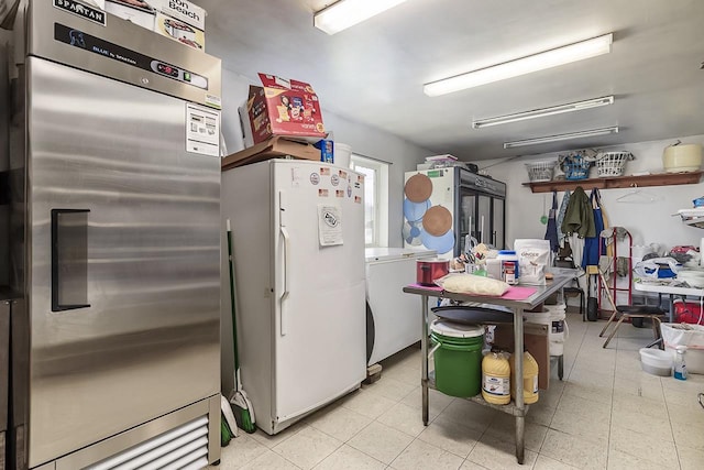 kitchen featuring white cabinets, white refrigerator, and high end refrigerator