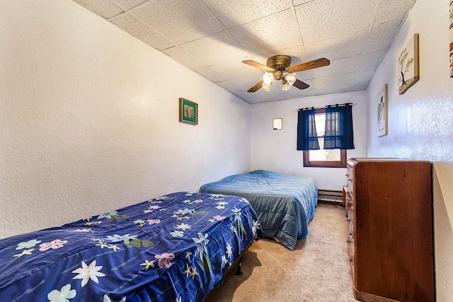 carpeted bedroom with baseboard heating and ceiling fan