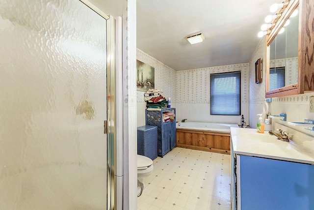 full bathroom featuring vanity, toilet, and independent shower and bath