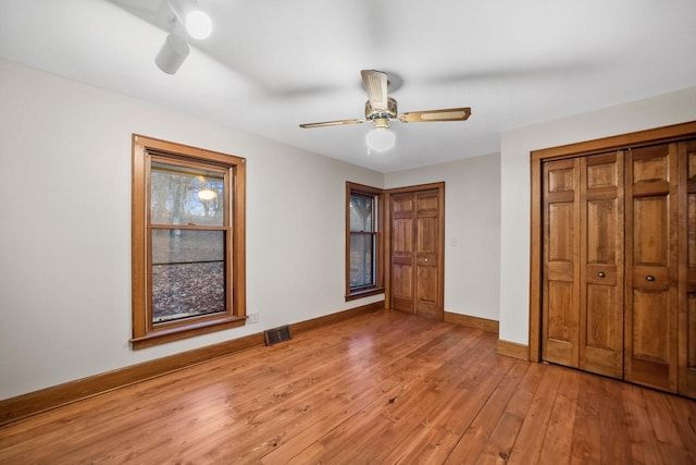 unfurnished bedroom featuring light hardwood / wood-style flooring and ceiling fan