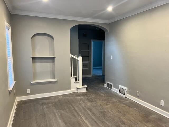 unfurnished room featuring dark hardwood / wood-style flooring and crown molding