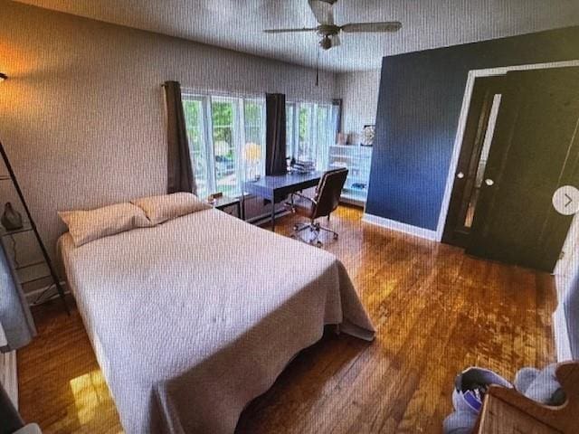 bedroom with ceiling fan and hardwood / wood-style floors