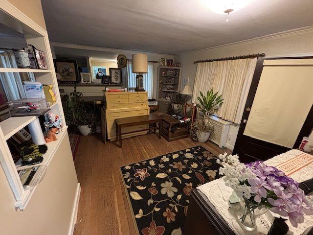 interior space with dark hardwood / wood-style flooring and ornamental molding