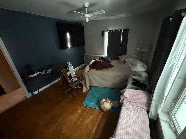 bedroom featuring ceiling fan and hardwood / wood-style flooring