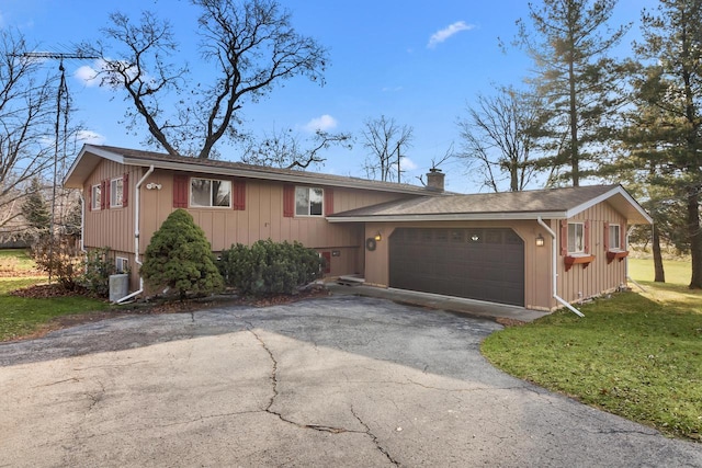 view of front of home with a garage and a front lawn