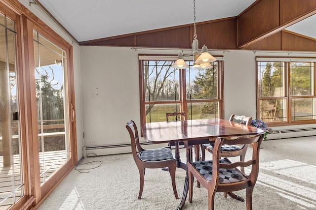 dining space featuring a notable chandelier, light colored carpet, lofted ceiling, and plenty of natural light