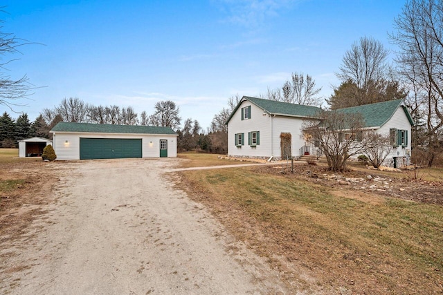 single story home with an outdoor structure, a front yard, and a garage