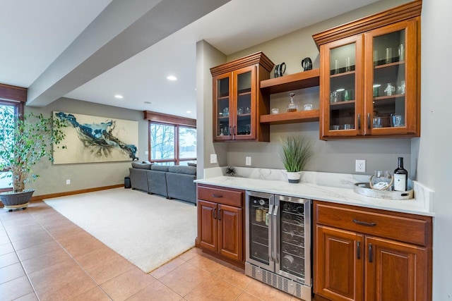 bar featuring light stone counters, light tile patterned floors, and wine cooler