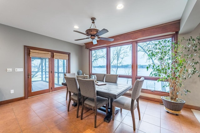 dining space with light tile patterned floors and ceiling fan