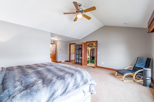 carpeted bedroom featuring a spacious closet, a closet, ceiling fan, and vaulted ceiling