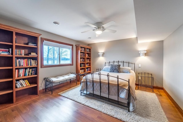 bedroom with wood-type flooring and ceiling fan