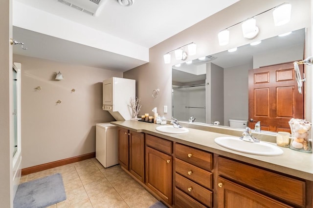 full bathroom featuring tile patterned floors, vanity, toilet, and enclosed tub / shower combo