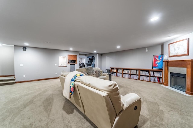 living room featuring a tiled fireplace and light colored carpet