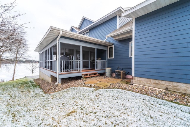 exterior space with a sunroom and central AC