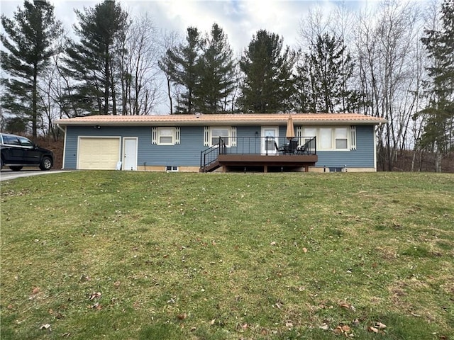 view of front of property featuring a wooden deck, a front lawn, and a garage