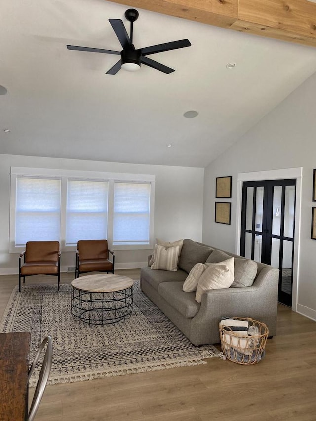 living room with vaulted ceiling with beams, ceiling fan, french doors, and hardwood / wood-style flooring