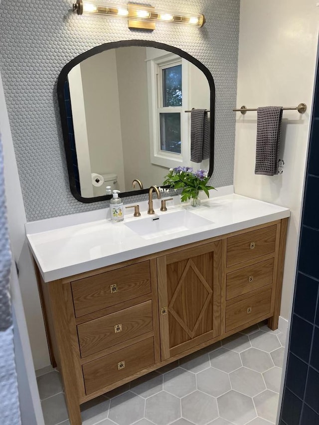 bathroom with tile patterned floors, vanity, and toilet