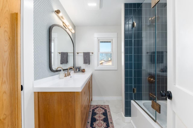 bathroom featuring tile patterned floors, vanity, and combined bath / shower with glass door