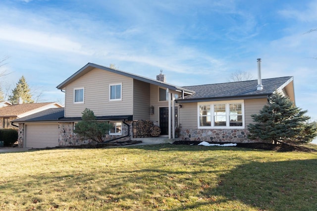 split level home featuring a front yard and a garage