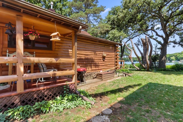 view of home's exterior featuring a wooden deck and a yard