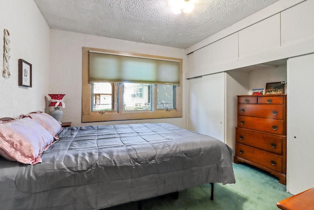 bedroom featuring light carpet and a textured ceiling