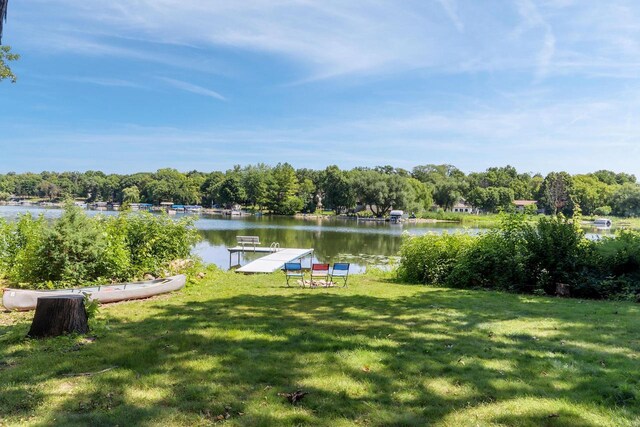 exterior space with a water view and a boat dock