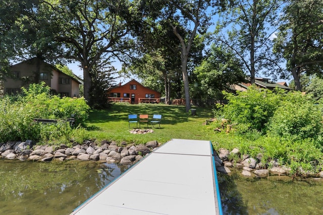 dock area featuring a yard and a water view