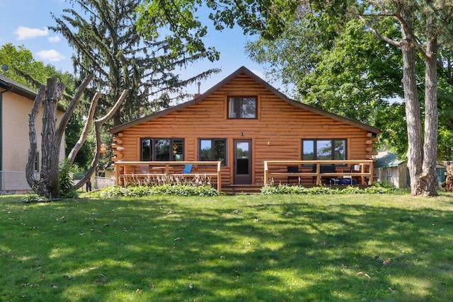 back of house featuring a lawn and a deck