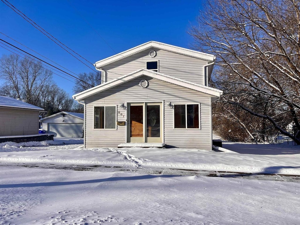 front of property with an outdoor structure and a garage