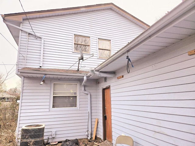 view of side of home with central AC unit