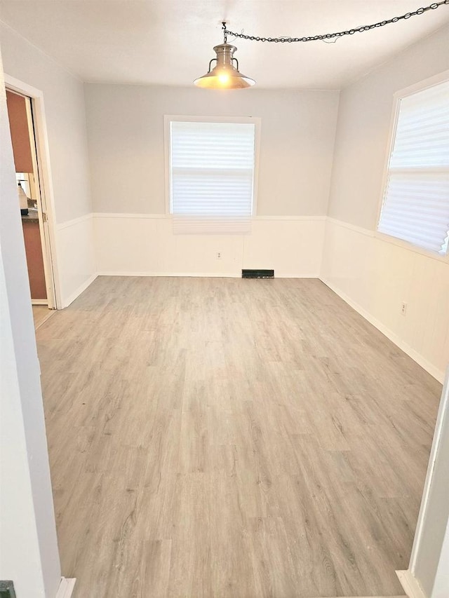 unfurnished room with light wood-type flooring