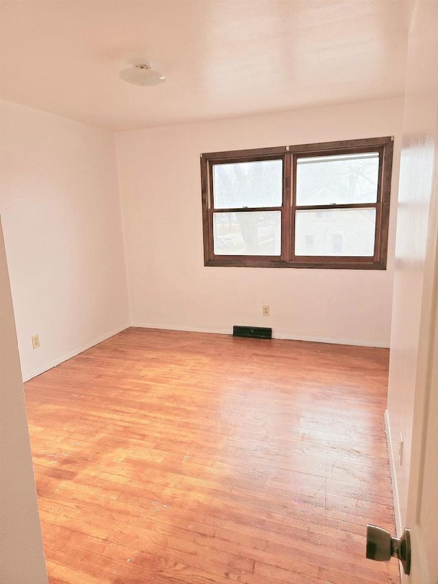 empty room featuring a healthy amount of sunlight and light wood-type flooring