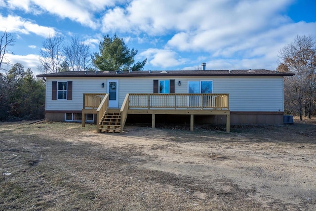 back of property featuring cooling unit and a wooden deck