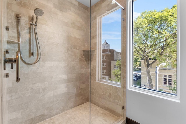 bathroom with plenty of natural light and a tile shower