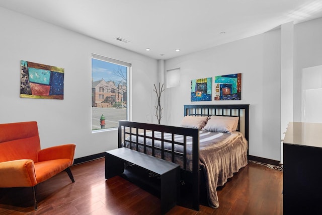 bedroom with dark hardwood / wood-style floors