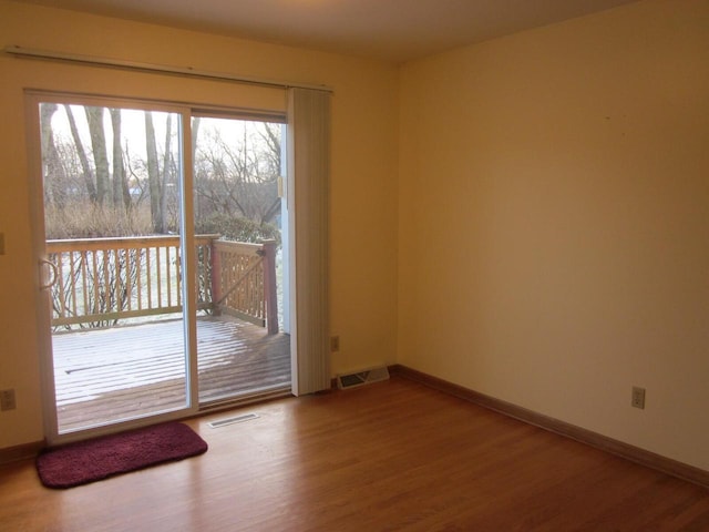 spare room featuring wood-type flooring