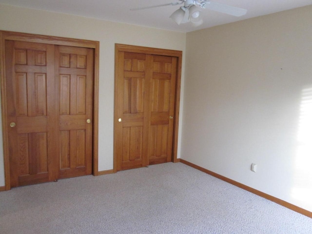 unfurnished bedroom featuring ceiling fan, a closet, and light carpet