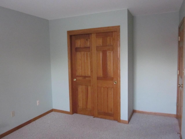 unfurnished bedroom with light colored carpet