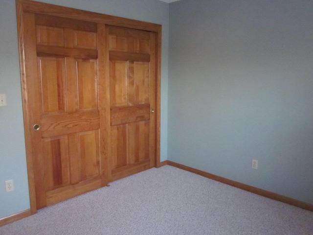 bedroom featuring a closet and light colored carpet