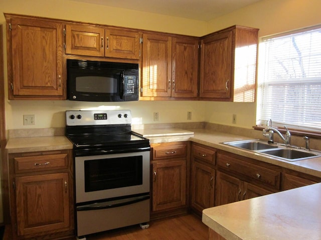 kitchen featuring dark hardwood / wood-style flooring, sink, and stainless steel electric range