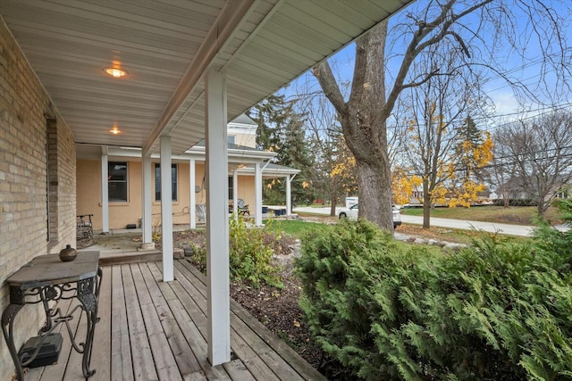 wooden terrace featuring covered porch